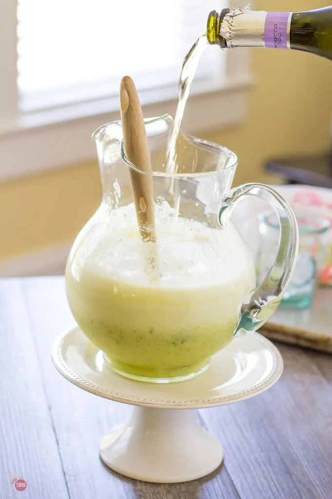 This pitcher style pineapple ginger prosecco punch is perfect with bubbly prosecco | Take Two Tapas | #Pineapple #Ginger #Prosecco #punch #Brunch #largebatch #Entertaining #easydrinks