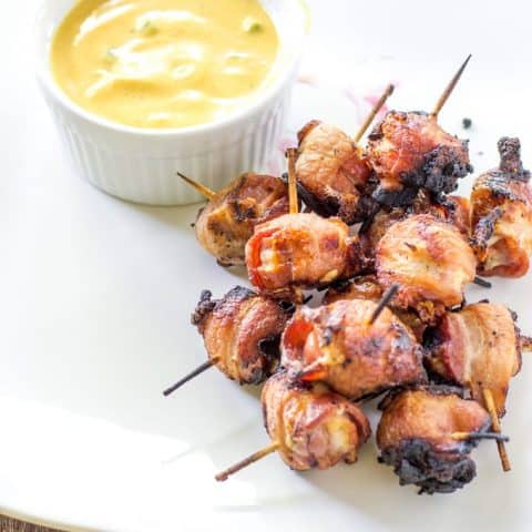 Hot Dog Bites with Smoky Bacon and summer sauce on a white platter