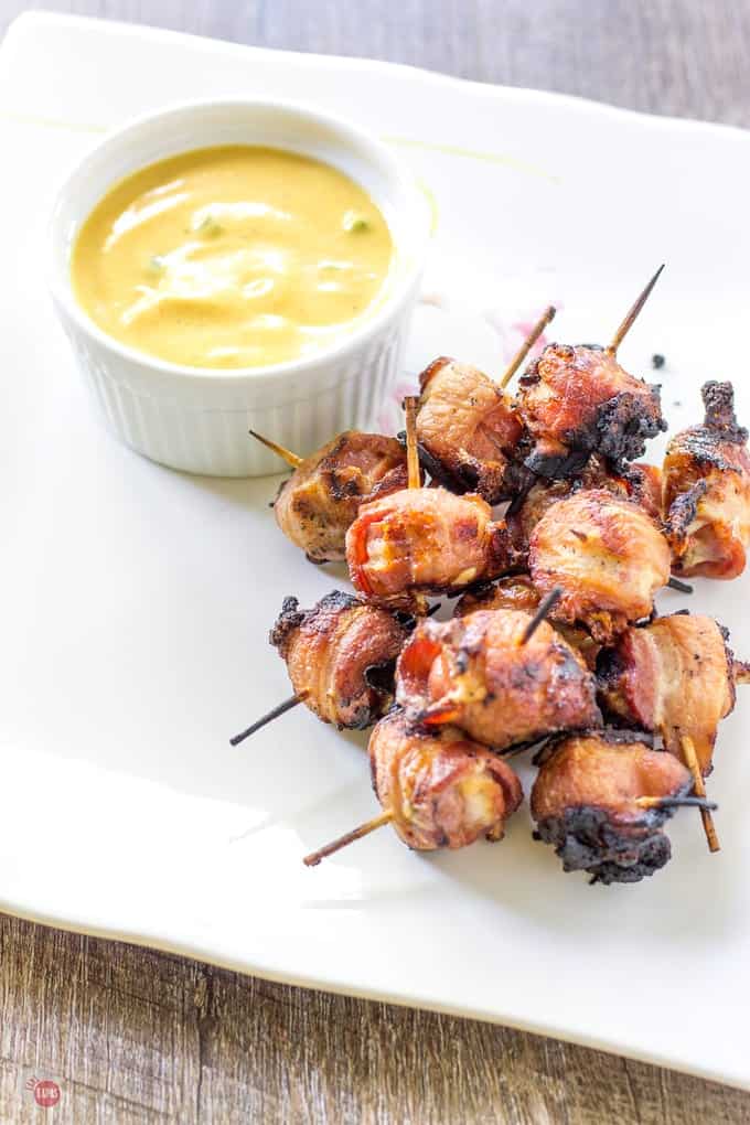 Hot Dog Bites with Smoky Bacon and summer sauce on a white platter