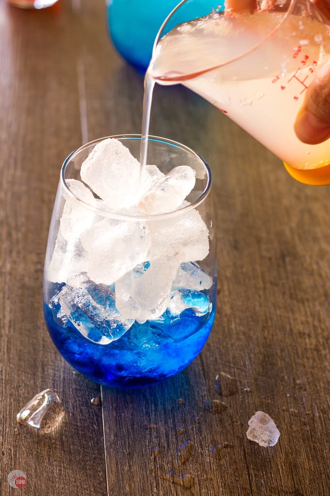 Pouring the limeade mix into the cocktail glass