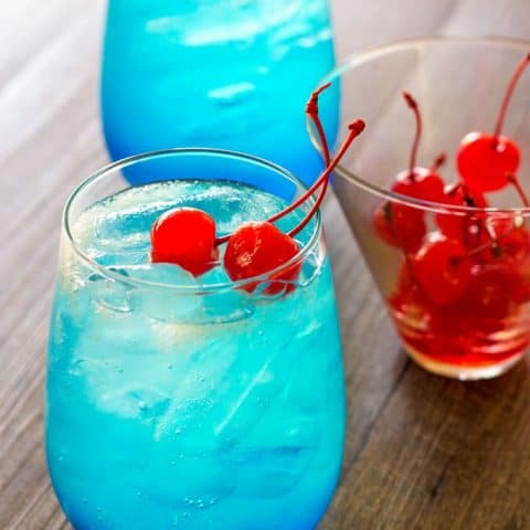 Space Pop Cocktail with Cherries on a wood surface