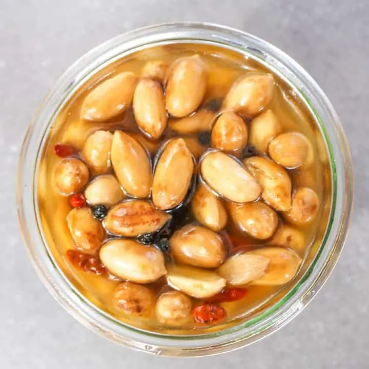 Overhead close up of Pickled Boiled Peanuts in a glass jar