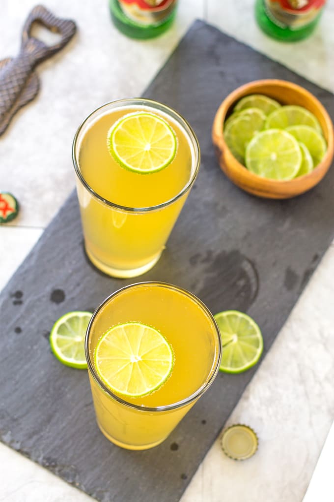 Float a lime wheel on top of the Margarita Beer Shandy | Take Two Tapas | #margarita #beer #Shandy #cocktails