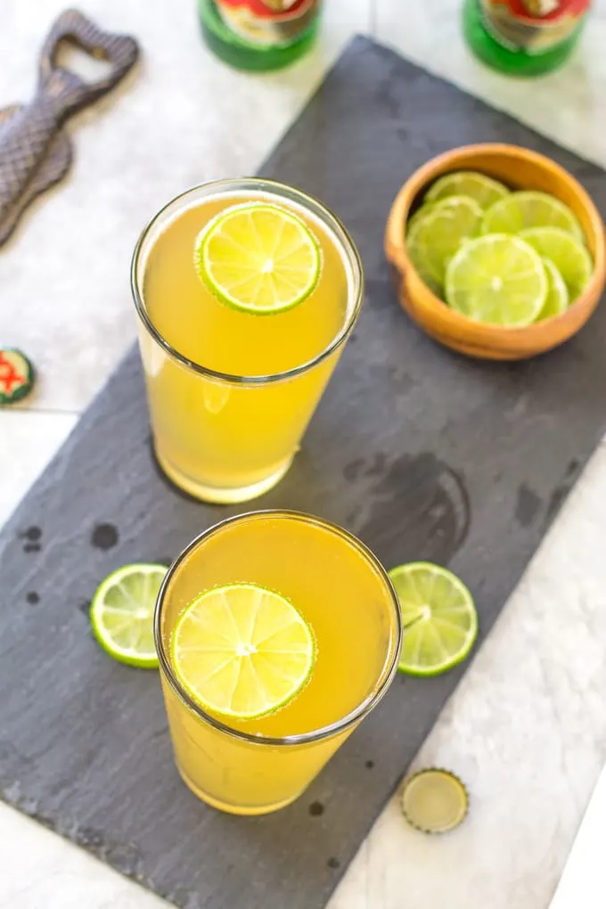 Float a lime wheel on top of the Margarita Beer Shandy | Take Two Tapas | #margarita #beer #Shandy #cocktails