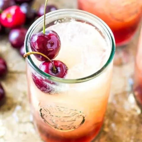 overhead of Cherry Amaretto Limeade Cocktail which is on a silver serving tray.