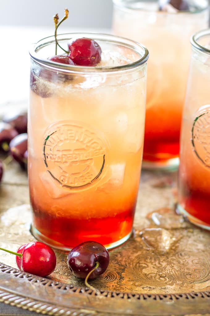 side view of cherry cocktails on a platter