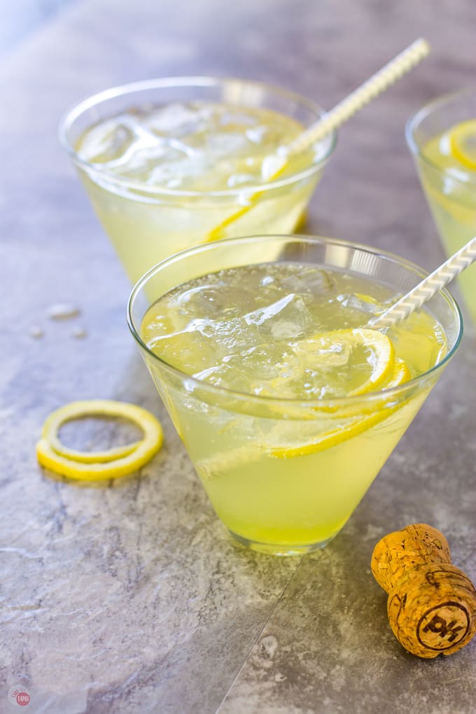 two stemless martini glasses with lemon cocktail