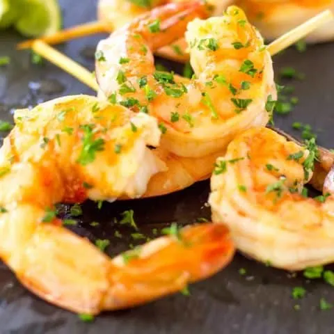 Up close picture of Spicy Margarita Shrimp Skewers on a slate.