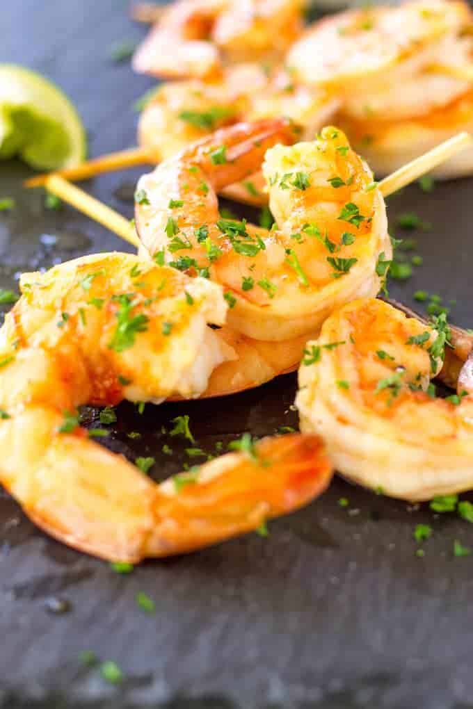 Up close picture of Spicy Margarita Shrimp Skewers on a slate.