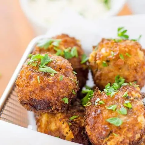 Fried Bacon Manchego Croquettes in a paper lined fry basket