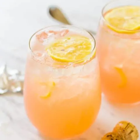 Close up of 2 Grapefruit Lemonade Crush Cocktails sitting on a white table