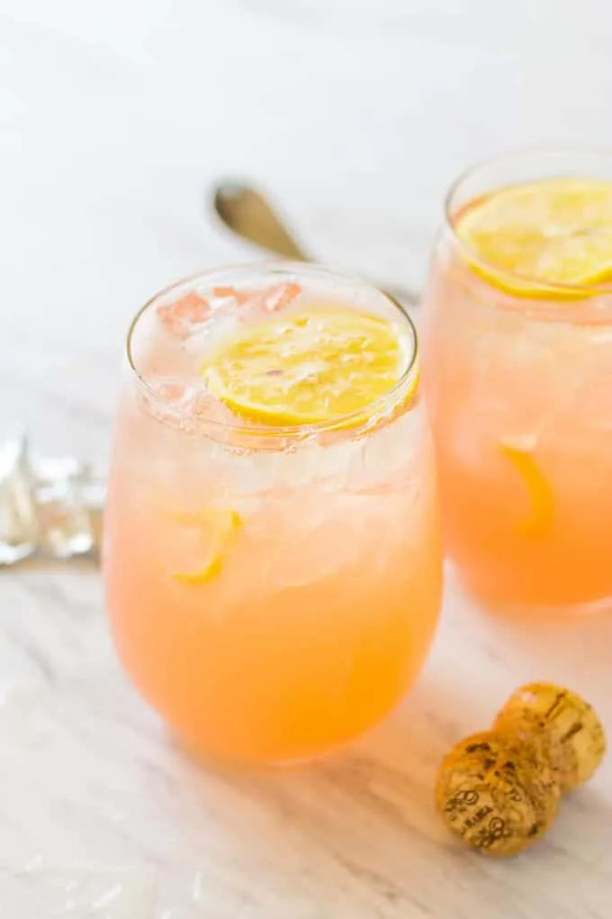 Close up of 2 Grapefruit Lemonade Crush Cocktails sitting on a white table
