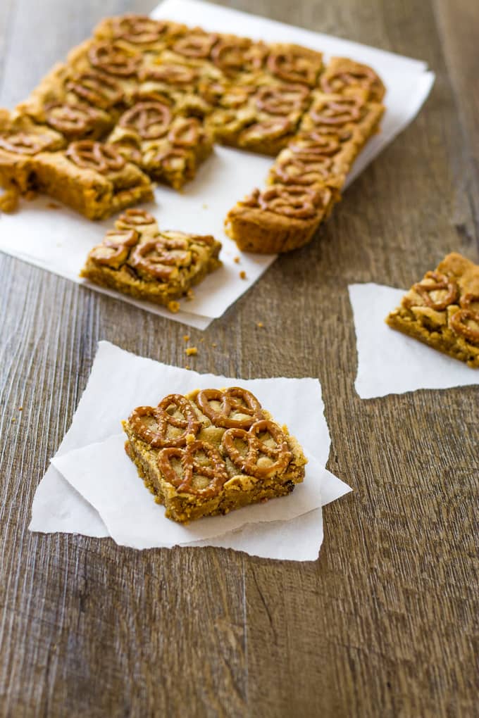 I could certainly use a tower of these peanut butter pretzel bars. Especially with bacon and borbon! | Take Two Tapas | #PeanutButter #Pretzels #PeanutButterBars #BrownieRecipe #Bacon #PeanutButterRecipes