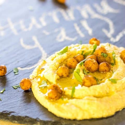 Shawarma Hummus with Roasted Chickpeas on a black slate platter
