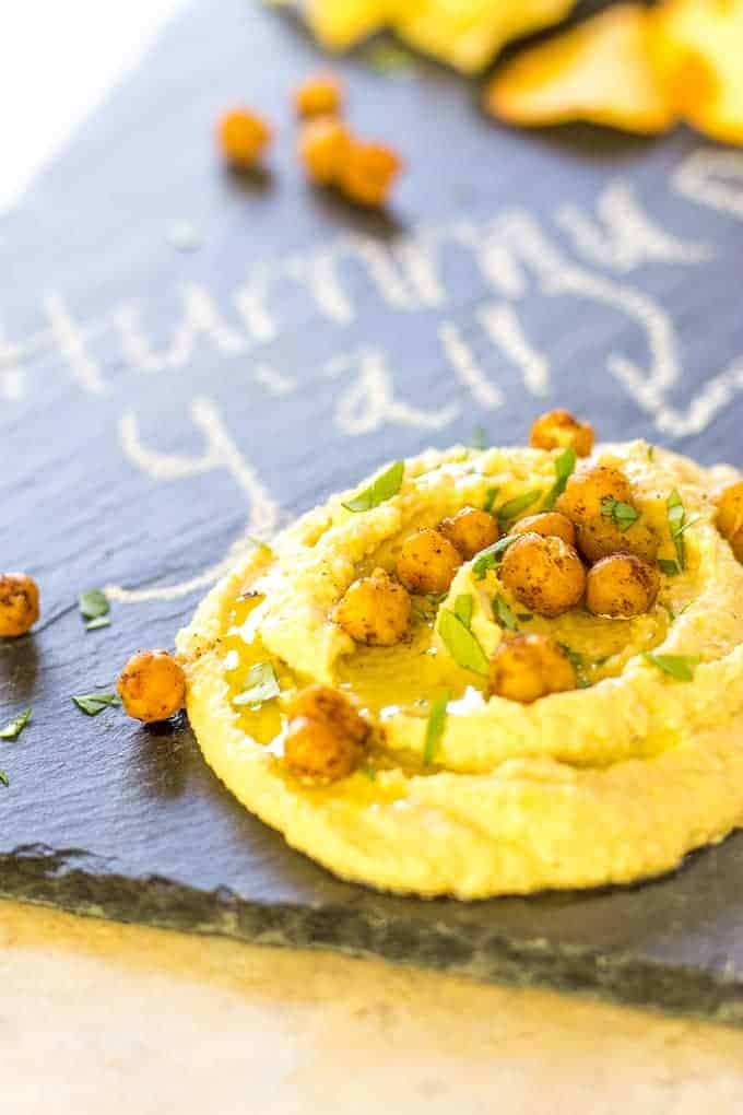 Shawarma Hummus with Roasted Chickpeas on a black slate platter