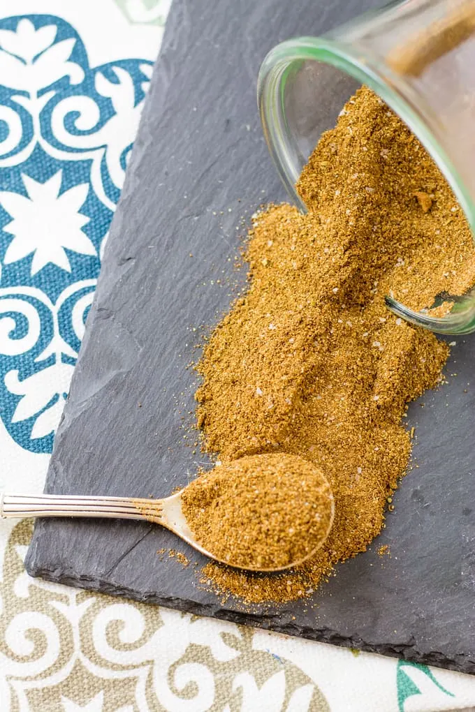 Shawarma Seasoning mix spilling onto a slate tray