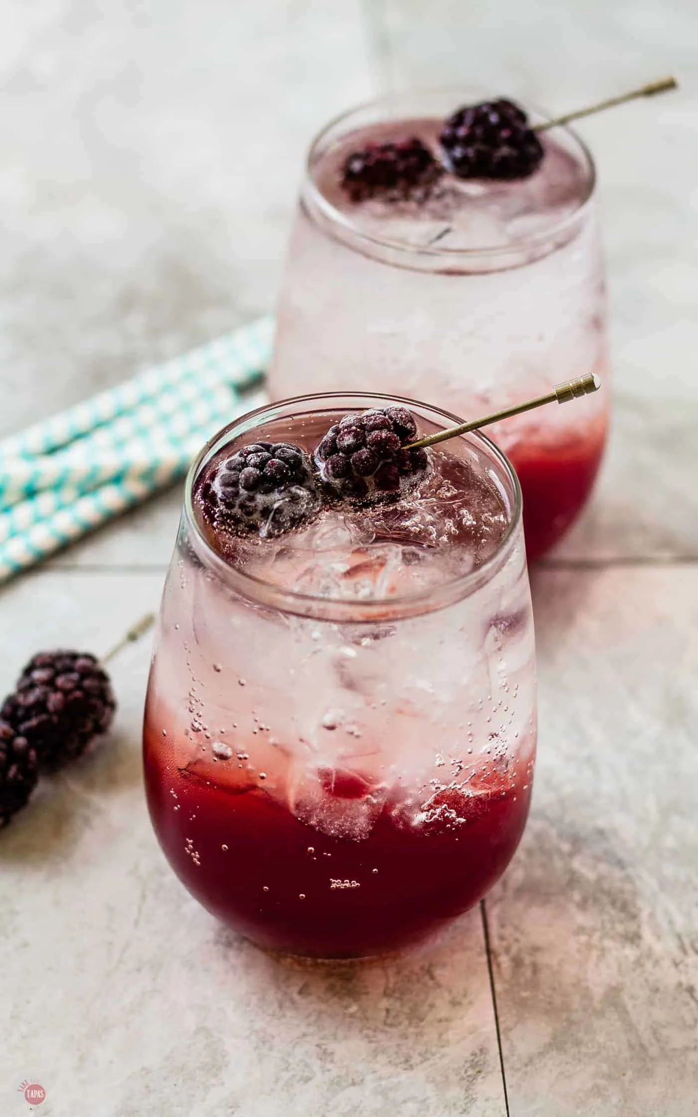 Blackberry Coconut Splash Cocktails on a light table with straws and blackberries
