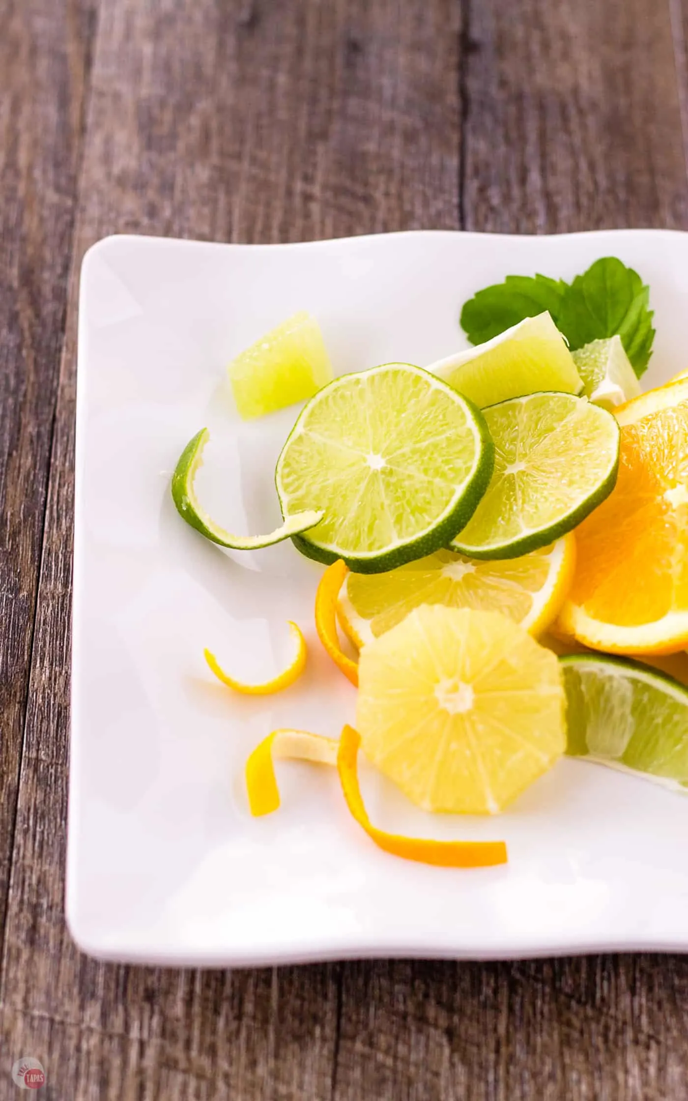 slices of Oranges, Lemons, Limes on a plate