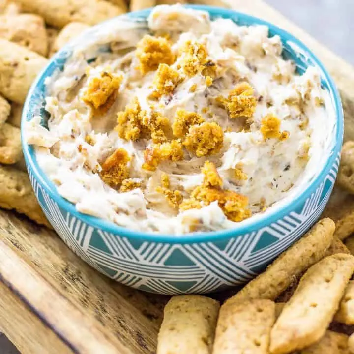 Oatmeal Cream Pie Dip with Cinnamon Sticks on a wood platter