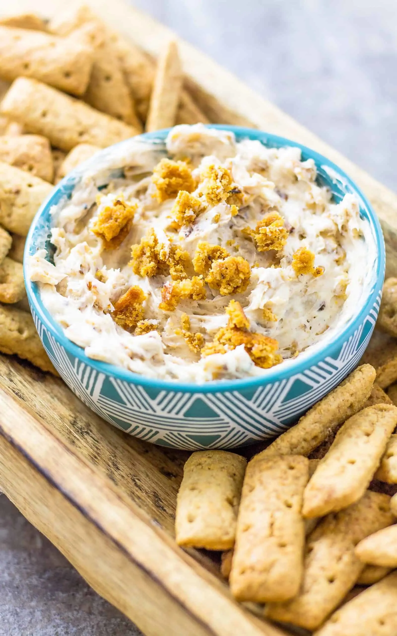 Oatmeal Cream Pie Dip with Cinnamon Sticks on a wood platter