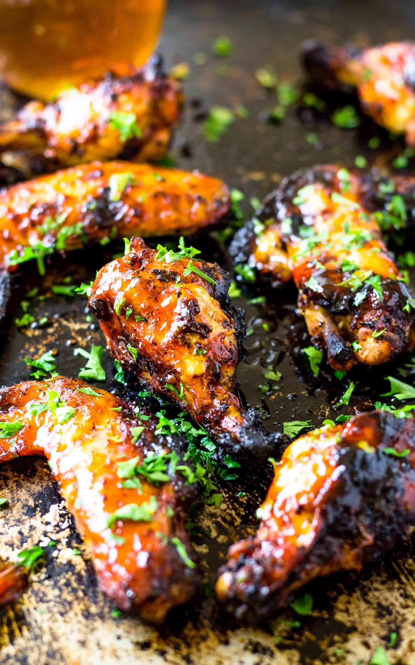 Sweet and Spicy Sriracha Honey Bourbon Chicken Wings on a pan