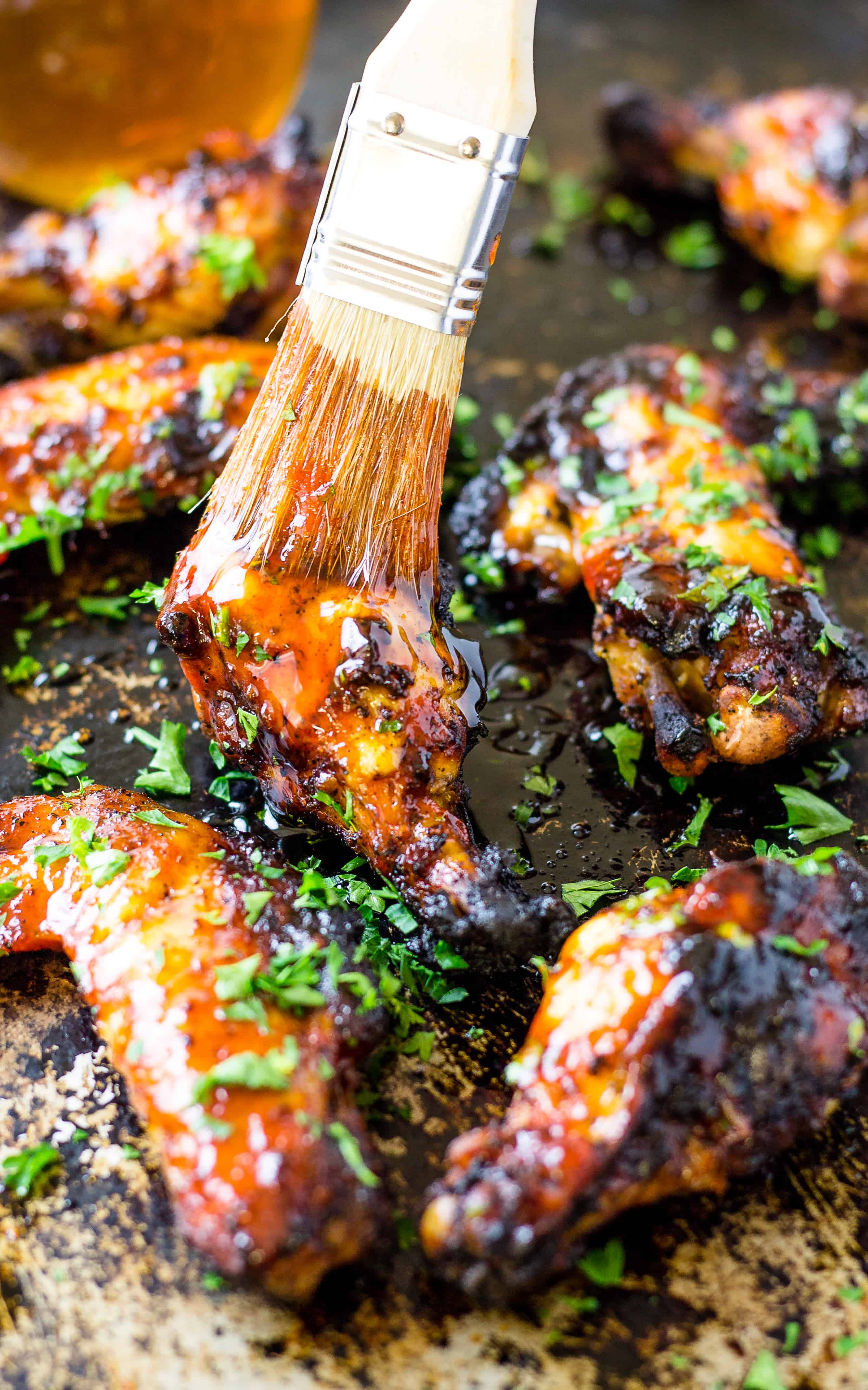 Brushing the sauce on the chicken wings