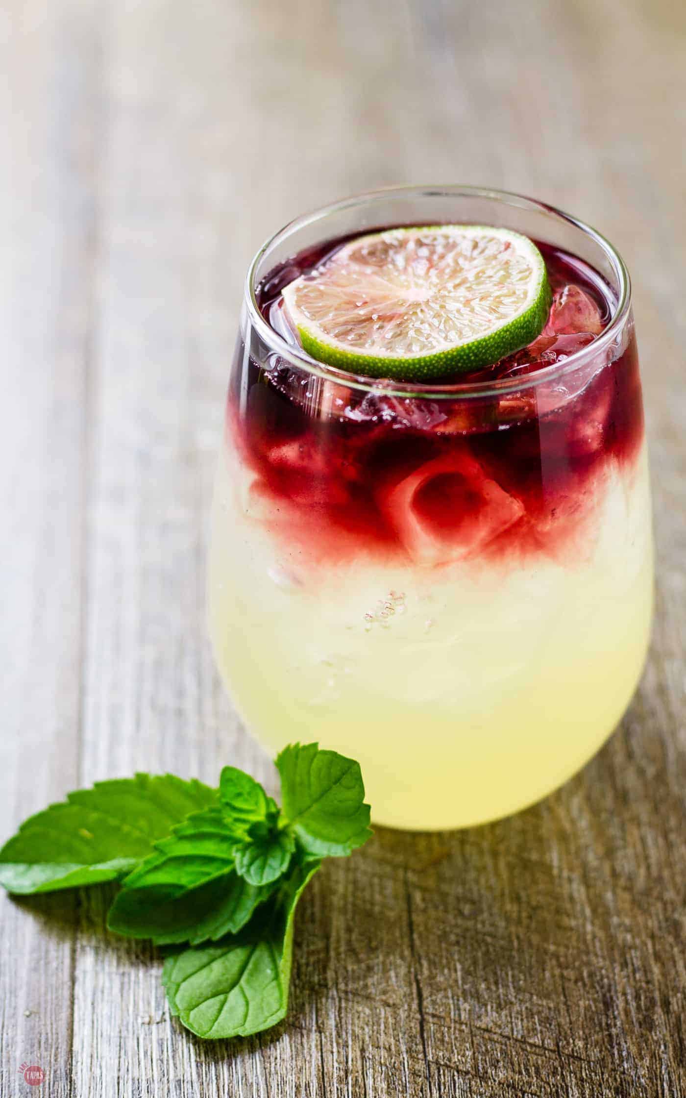 Wimade is homemade limeade made with honey and topped with red wine | Take Two Tapas | #Wimade #Wine #Limeade #HoneyLimeade #Wine #LayeredCocktail #honey