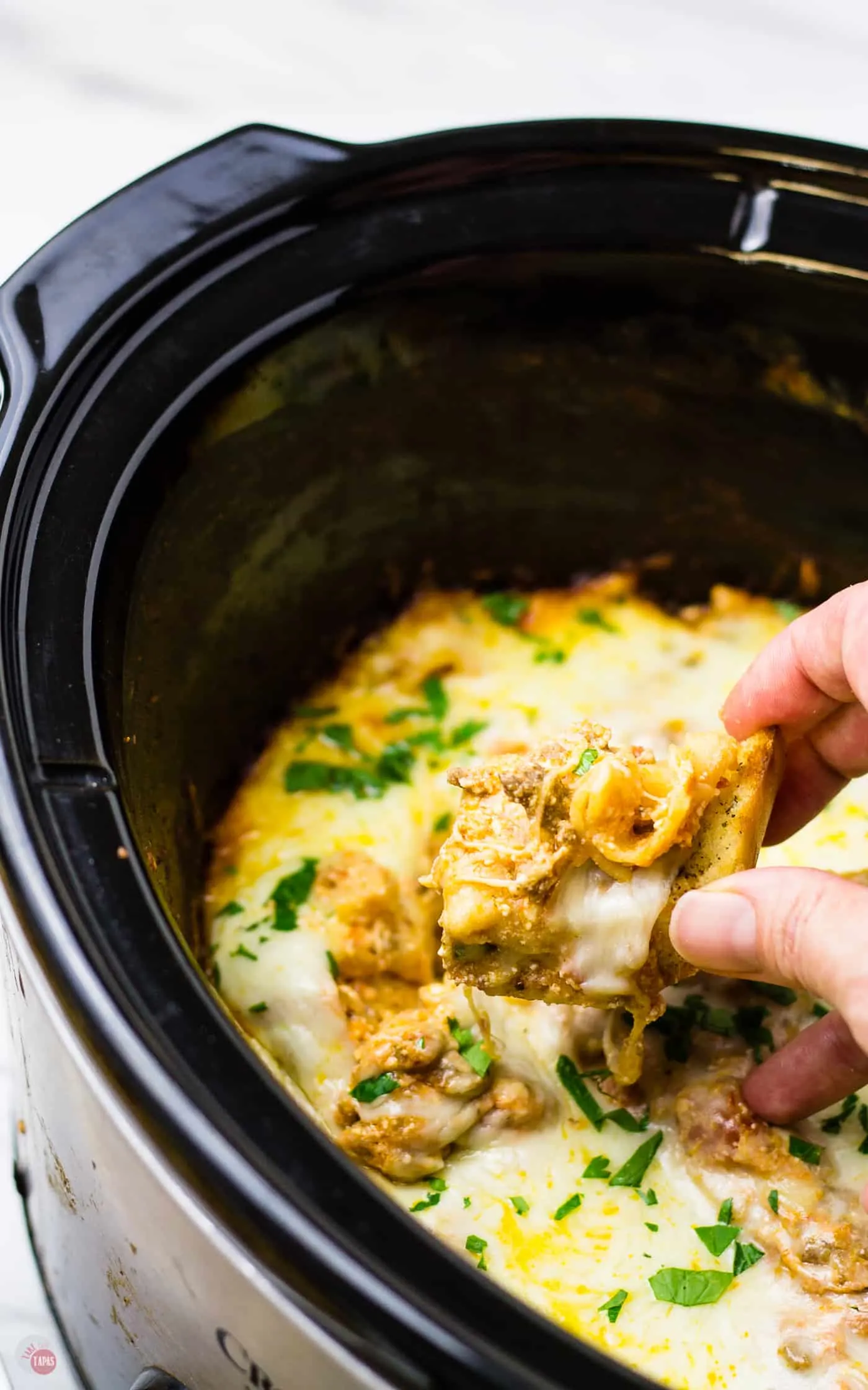 I use garlic bread to scoop up this crockpot lasagna dip