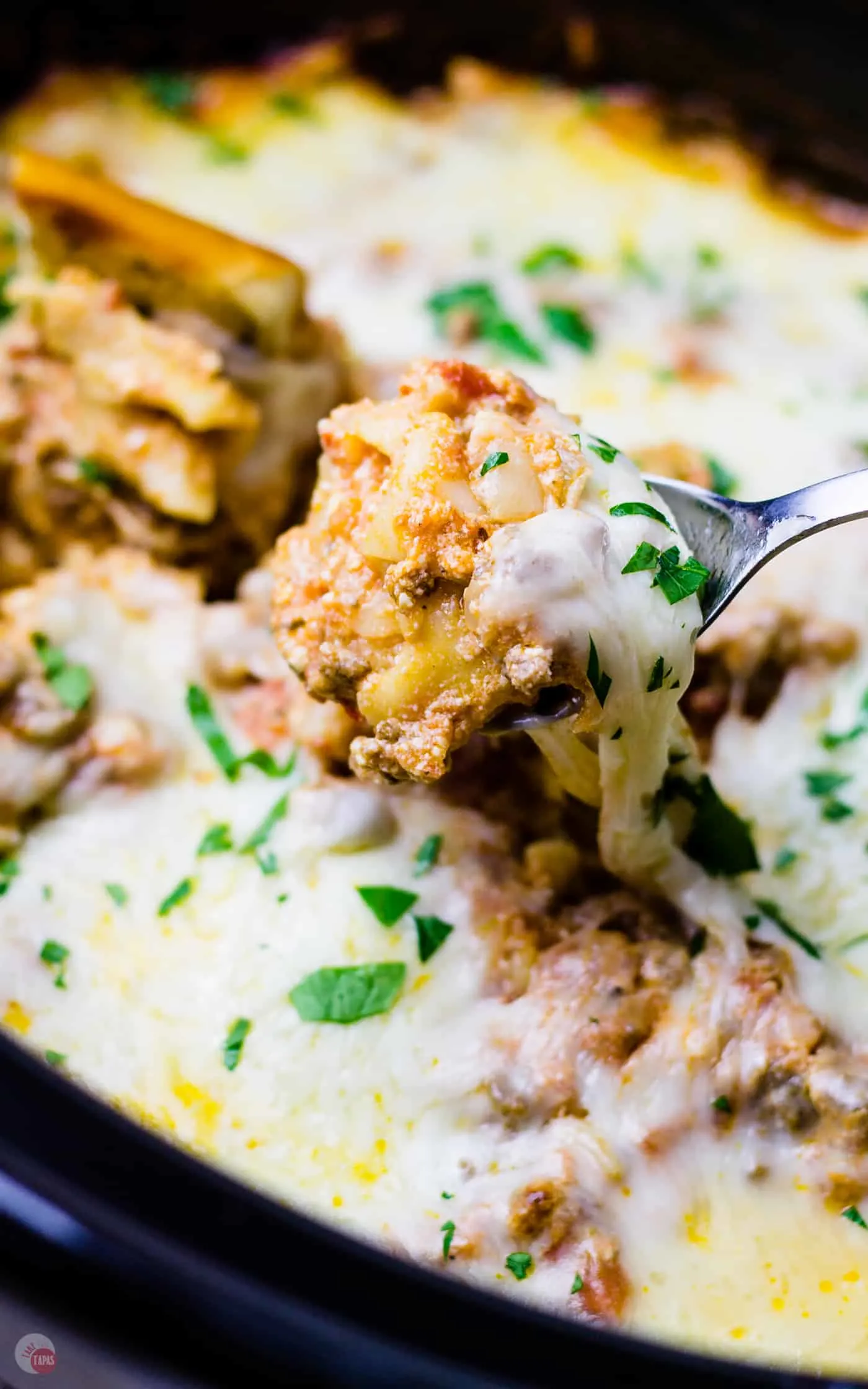This crockpot lasagna dip wouldn't be complete without some pasta and extra cheese!