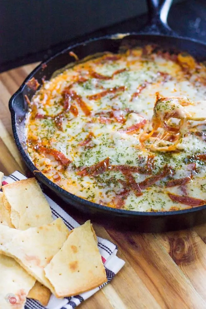 Extra Cheesy Pepperoni Pizza Skillet Dip and pita bread on a wood table