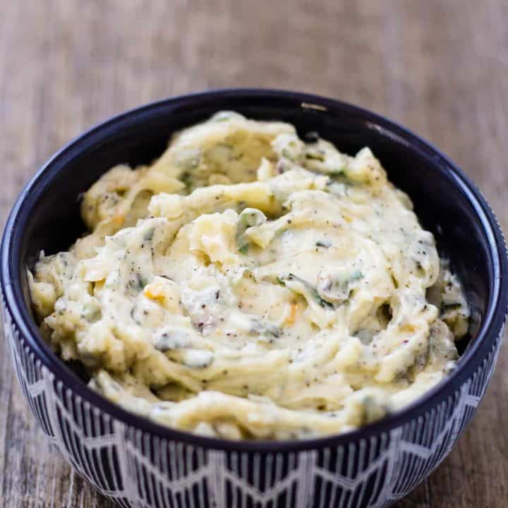 roasted garlic spread with herbs in a serving bowl