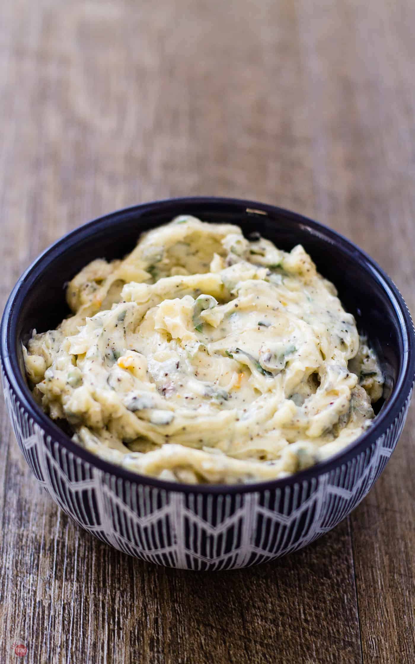roasted garlic spread with herbs in a serving bowl