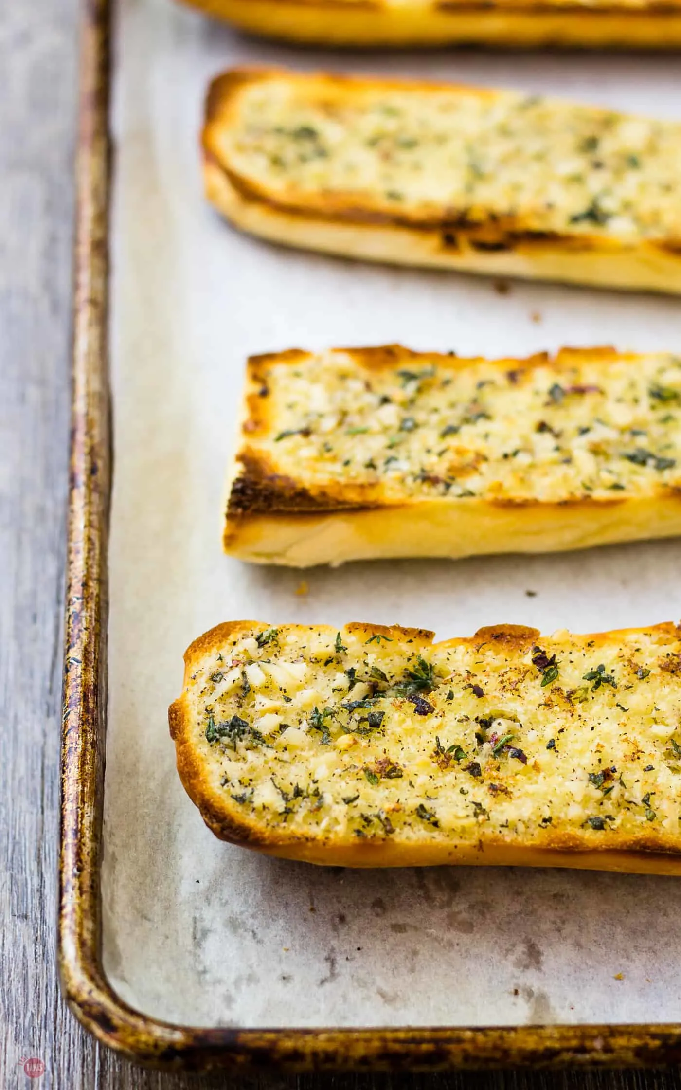 I love the crispy edges of garlic bread so I make my own with my roasted garlic spread | Take Two Tapas | #RoastedGarlic #CompoundButter #FreshHerbs #ButterRecipe #GarlicSpread