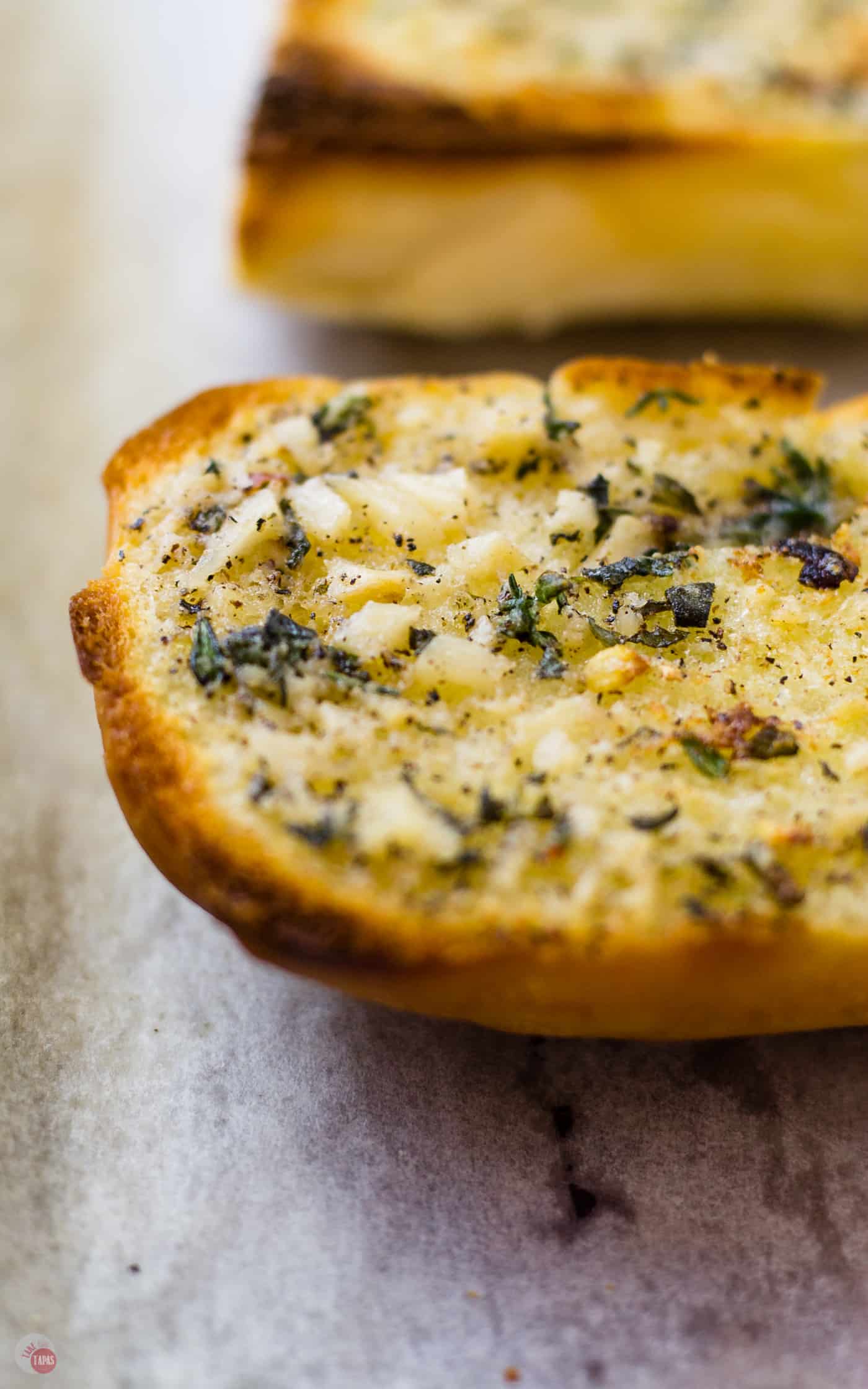 When all the butter melts and crisps up the bread you are left with herbs and roasted garlic. Roasted Garlic Spread | Take Two Tapas | #RoastedGarlic #CompoundButter #FreshHerbs #ButterRecipe #GarlicSpread