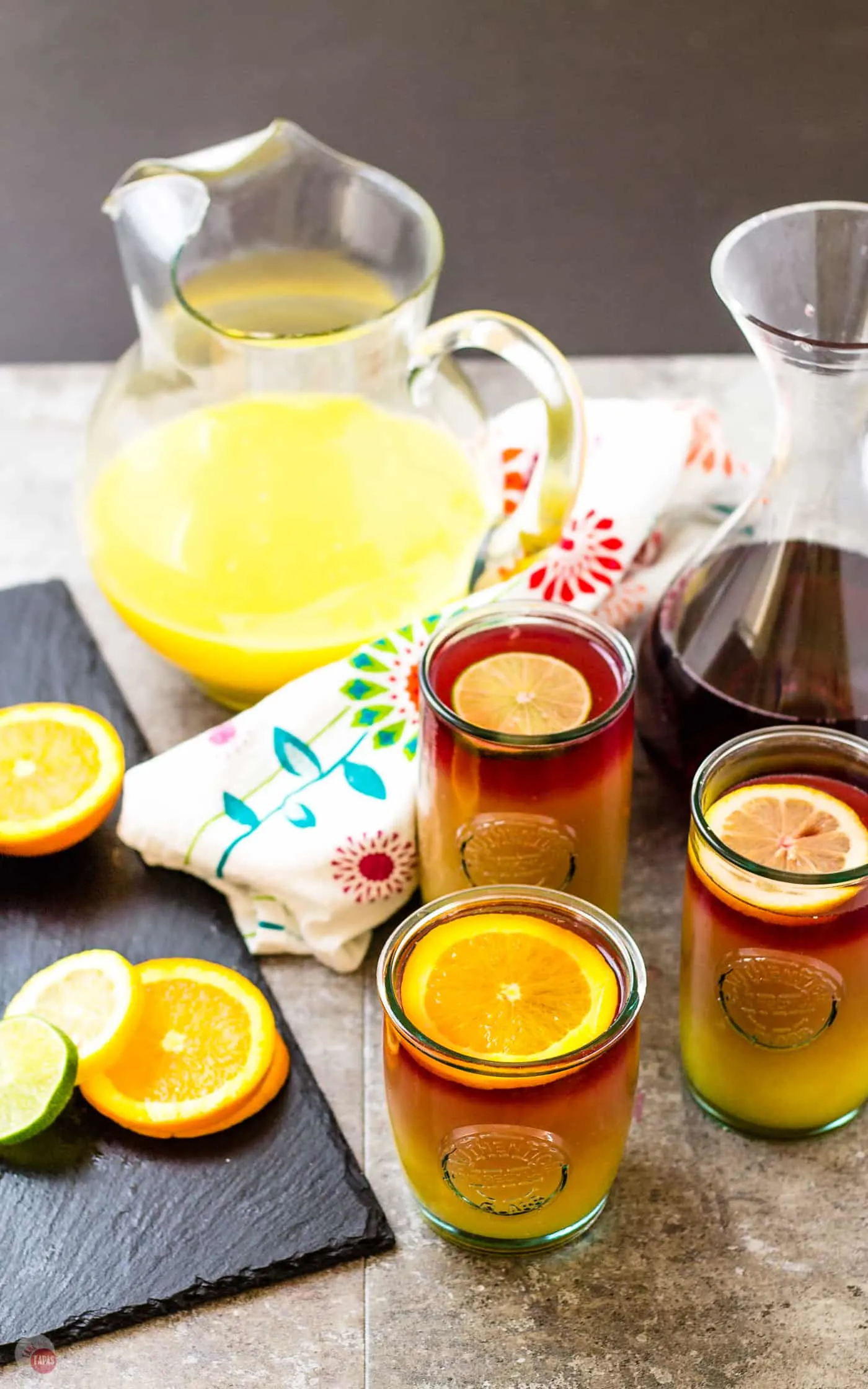 get your sangria on with my Sangria Sunrise Cocktail | Take Two Tapas | #Sangria #TequilaSunrise #LayeredCocktail #OrangeJuice #TequilaCocktails #BrunchCocktails