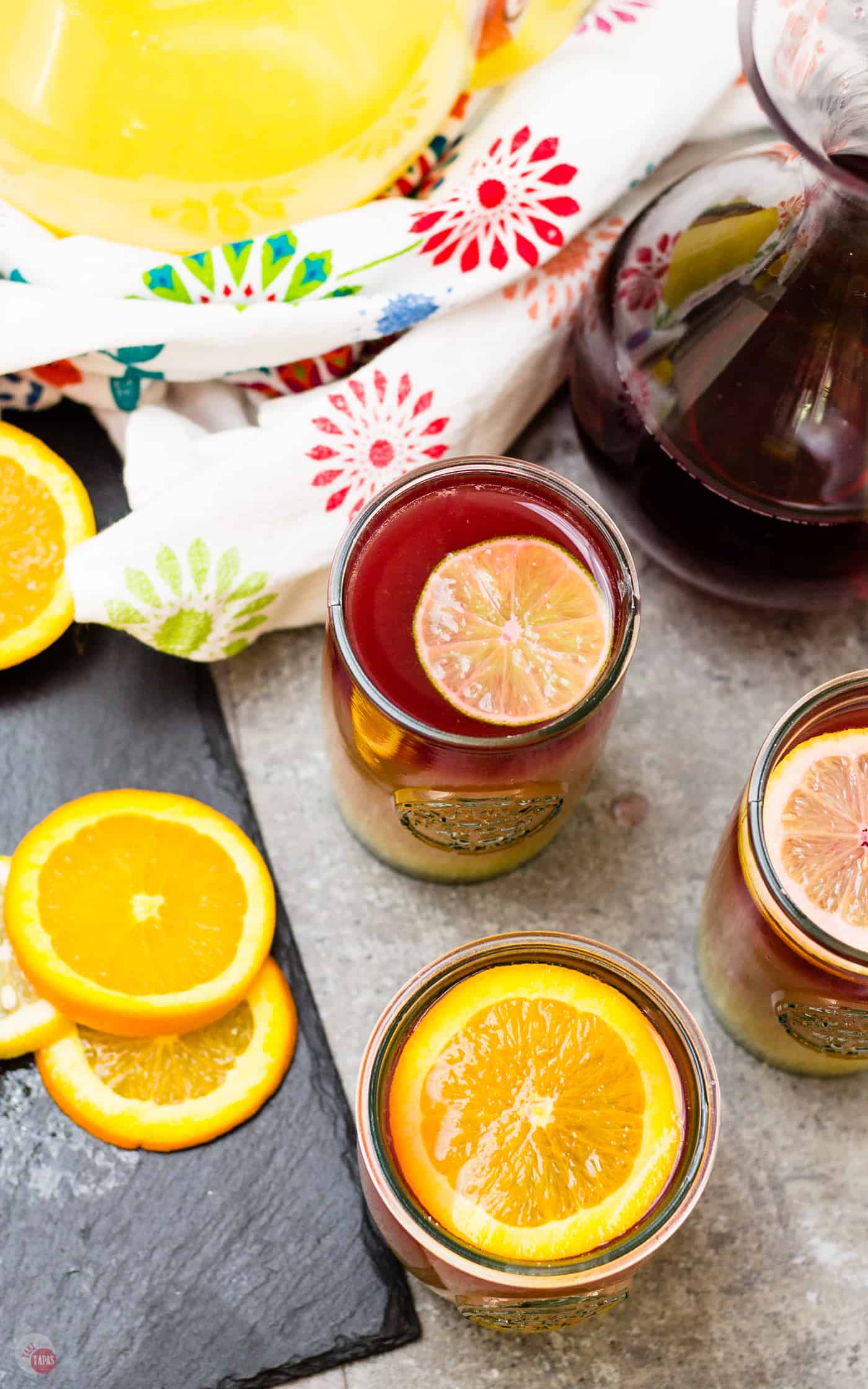 My Sangria Sunrise makes a great large batch punch! | Take Two Tapas | #Sangria #TequilaSunrise #LayeredCocktail #OrangeJuice #TequilaCocktails #BrunchCocktails