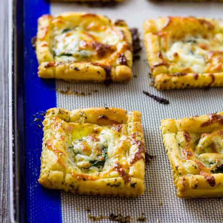 close up of White PIzza Mini Tarts on a sheet pan