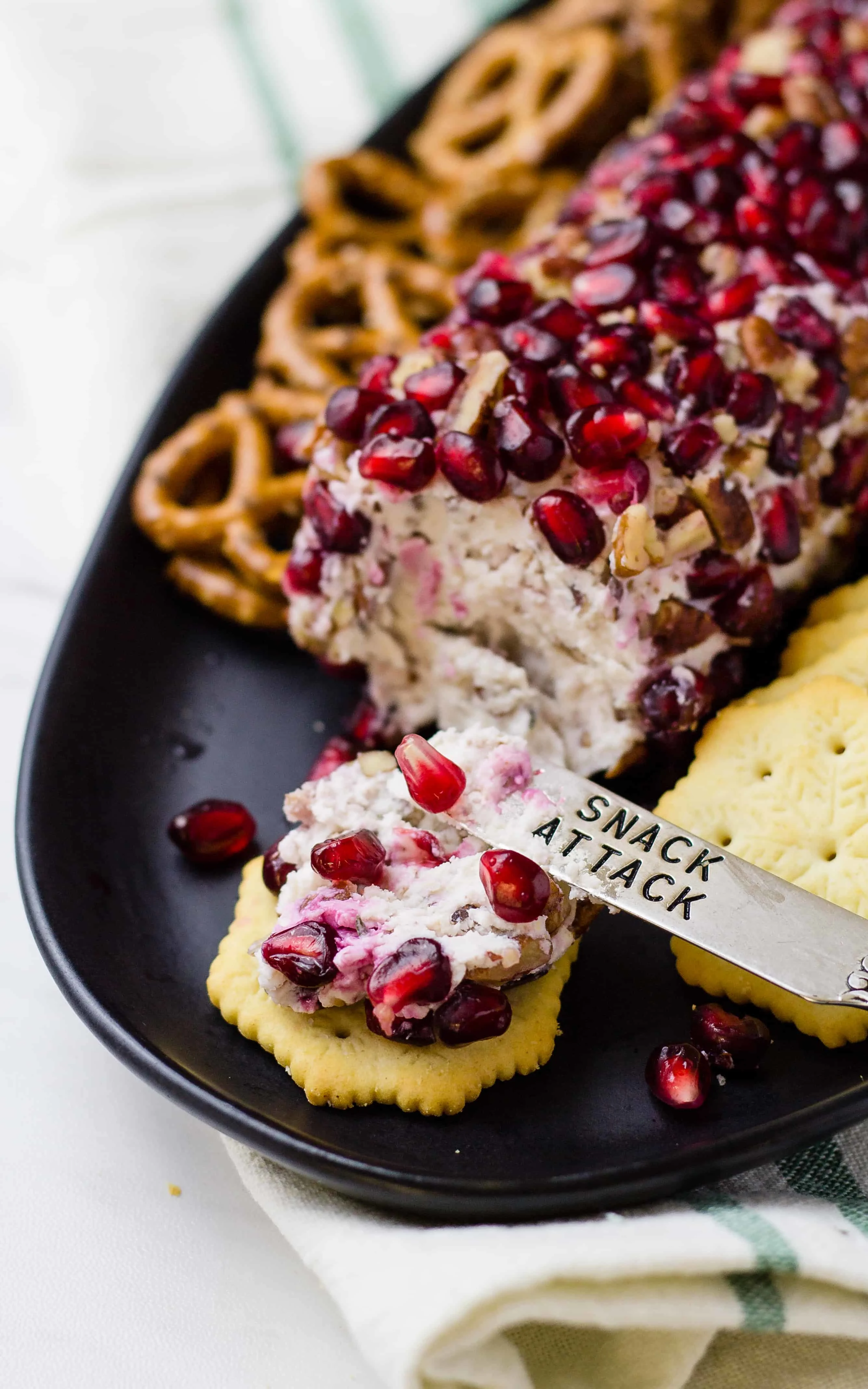 A cracker recently spread with the Drunken pomegranate goat cheese log