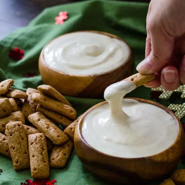 dipping a graham cracker stick in to the spiked eggnog dip.