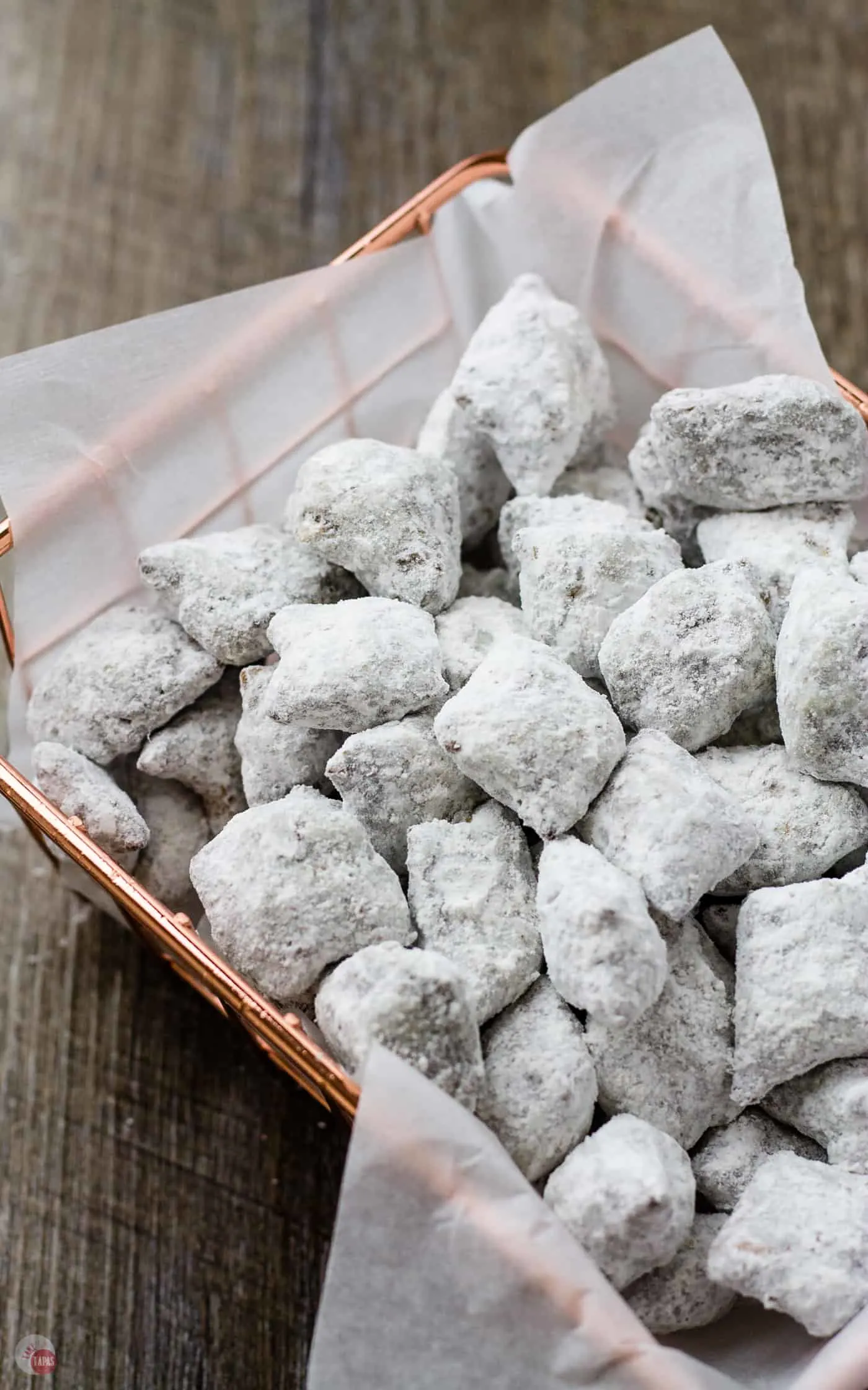 Peanut butter pretzel puppy chow in a lined basket