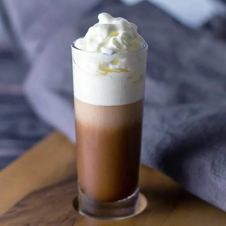 Close up look at Salted Caramel Kahlua Layer Shot on a serving board with a grey napkin behind it