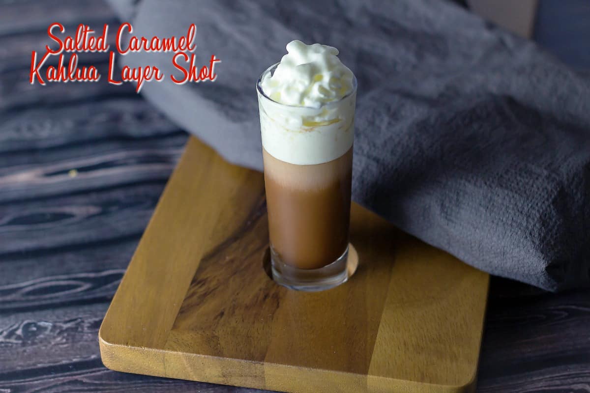Salted Caramel Kahlua Layer Shot on a serving board with a grey napkin behind it
