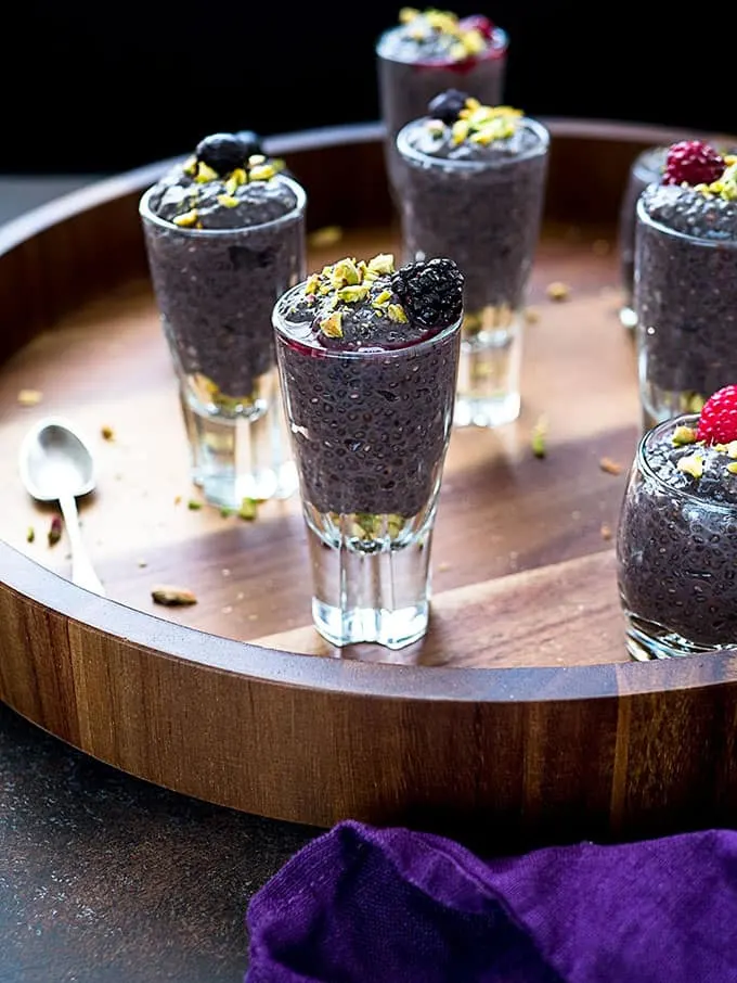 Berry chia dessert pudding shooters on a round tray