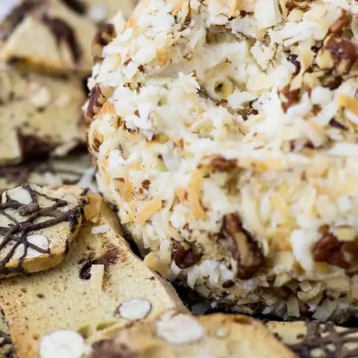 close up of Italian Cream Cake Cheese Ball and thin biscotti cookie pieces on a plate