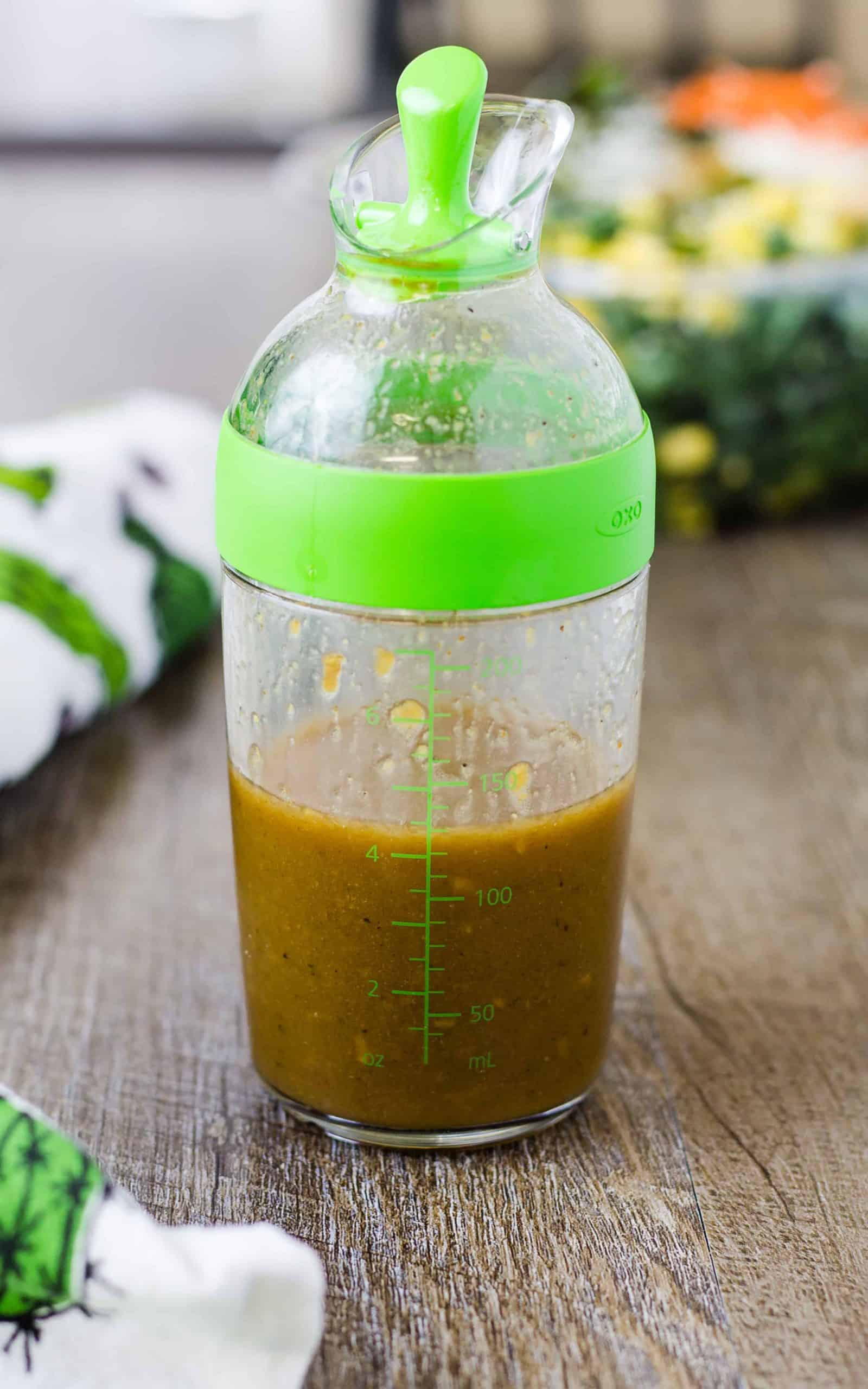Delicious Homemade Balsamic Vinaigrette Salad Dressing in a dressing container on a wood surface