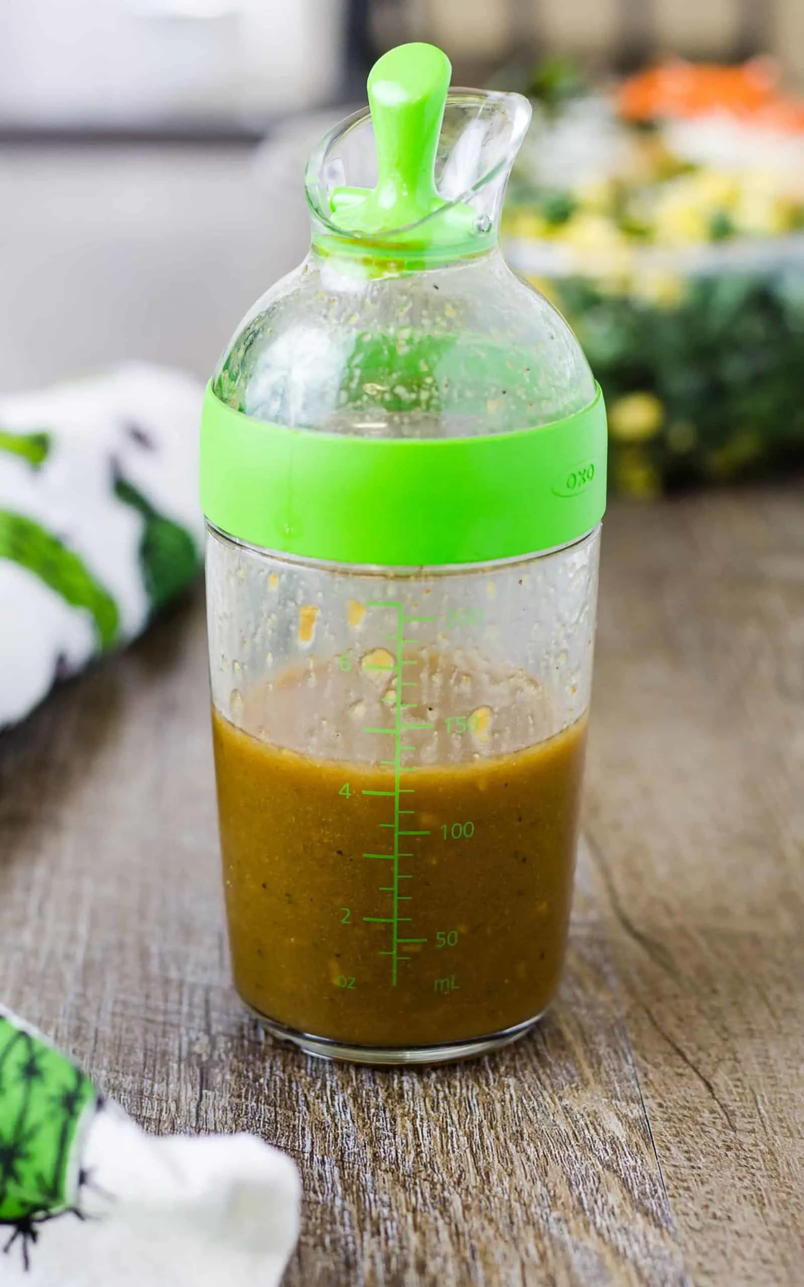 Delicious Homemade Balsamic Vinaigrette Salad Dressing in a dressing container on a wood surface
