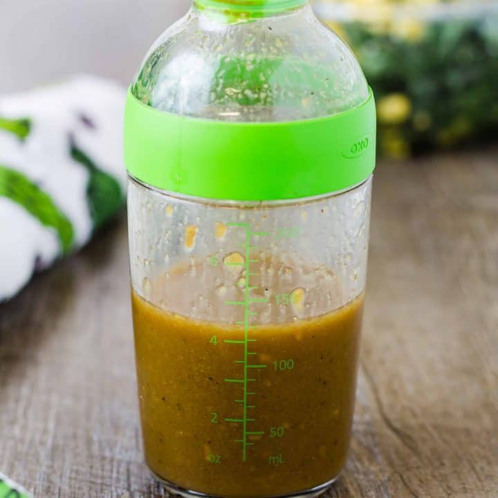 Roasted Ginger Vinaigrette Salad Dressing in a Dressing container on a wood surface