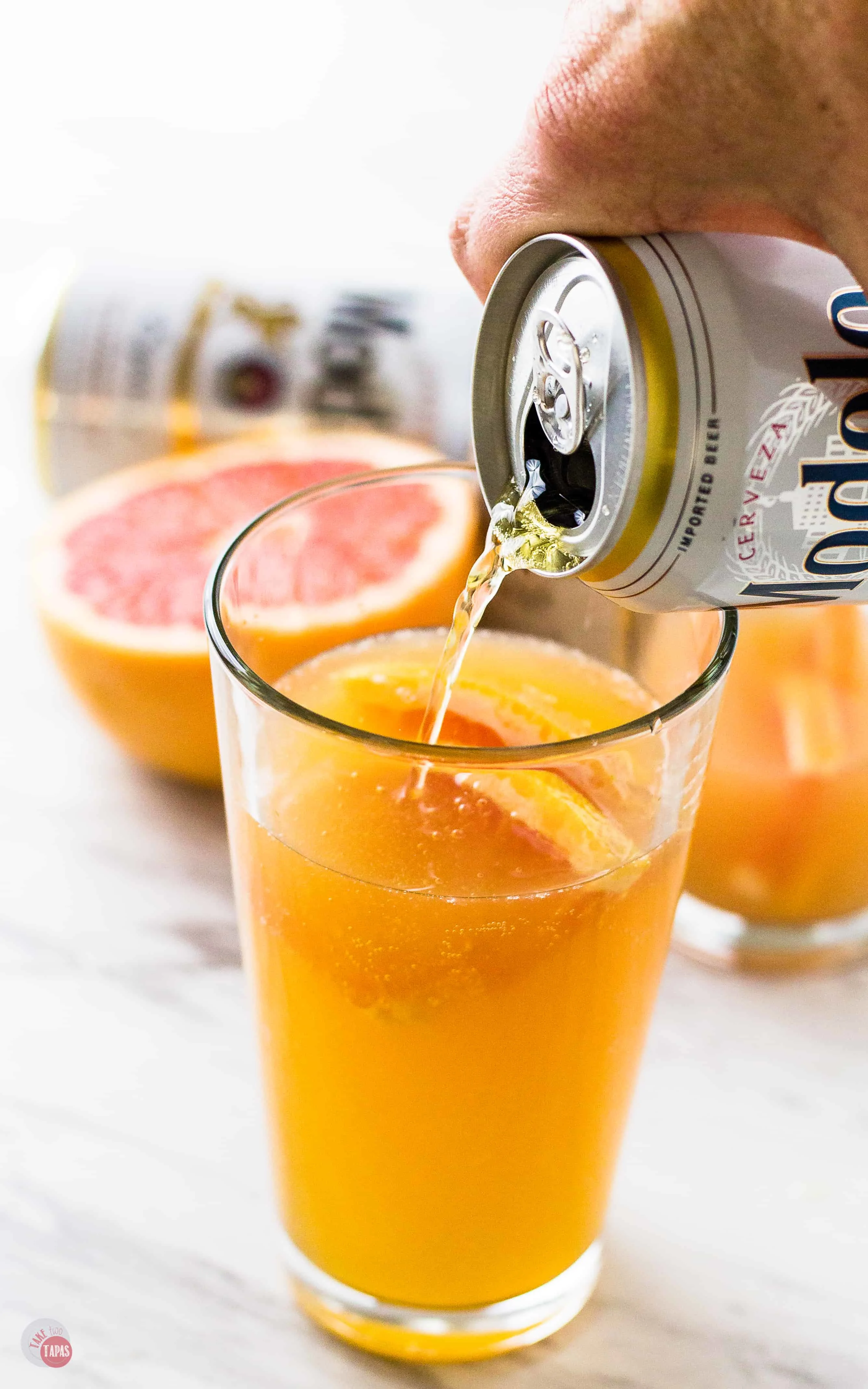 Pour the beer in slowly to keep the foam to a minimum in your Grapefruit Shandy | Take Two Tapas | #Grapefruit #Shandy #GrapefruitShandy #Beer #Cocktail #Tequila #Summer #AD #CelebratorySips #CelebrateWithModelo