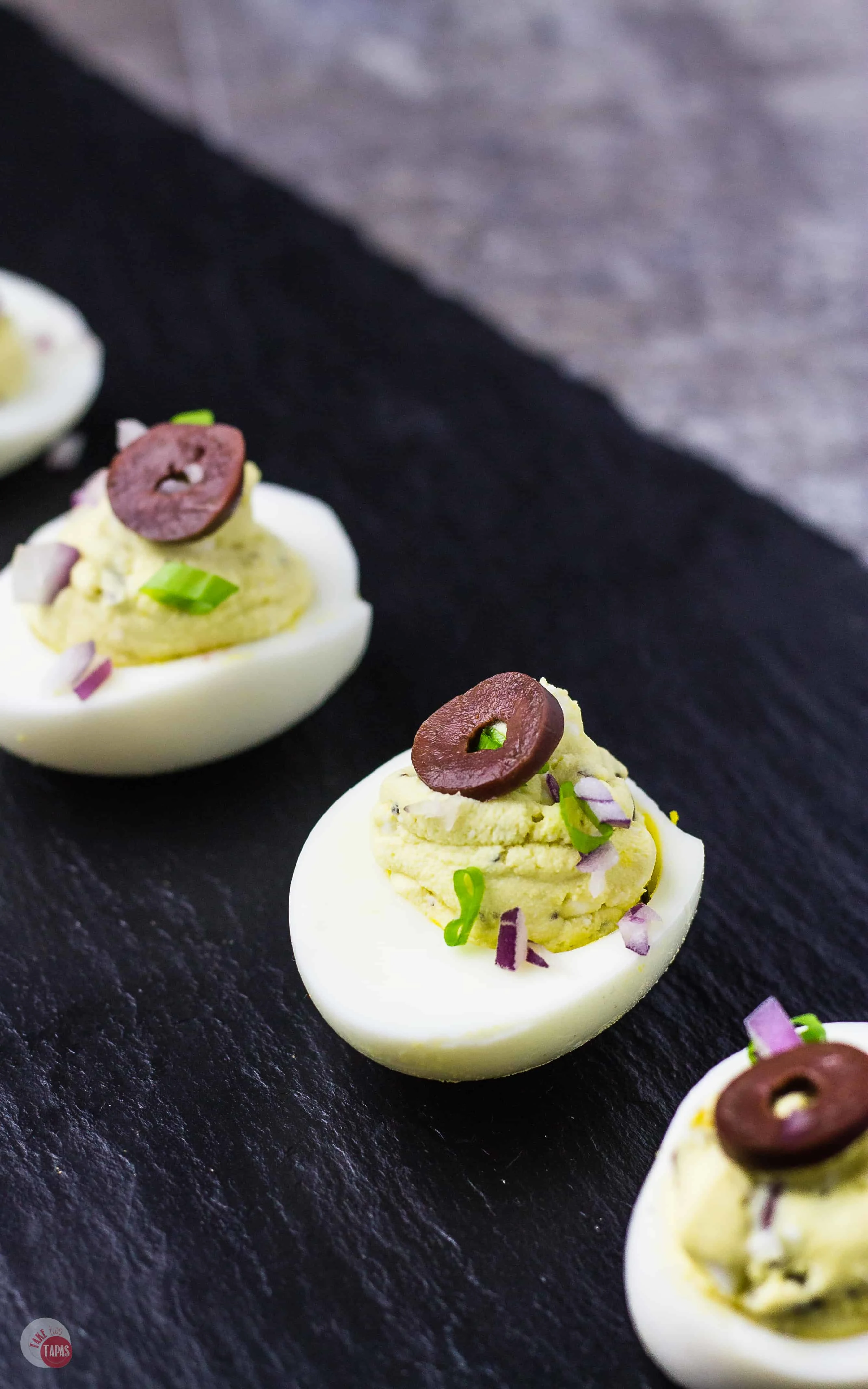 Exotic Flavors in these Mediterranean Deviled Eggs shine with feta | Take Two Tapas | #Mediterranean #Feta #DeviledEggs #Kalamata #Olives #Easter #MothersDay
