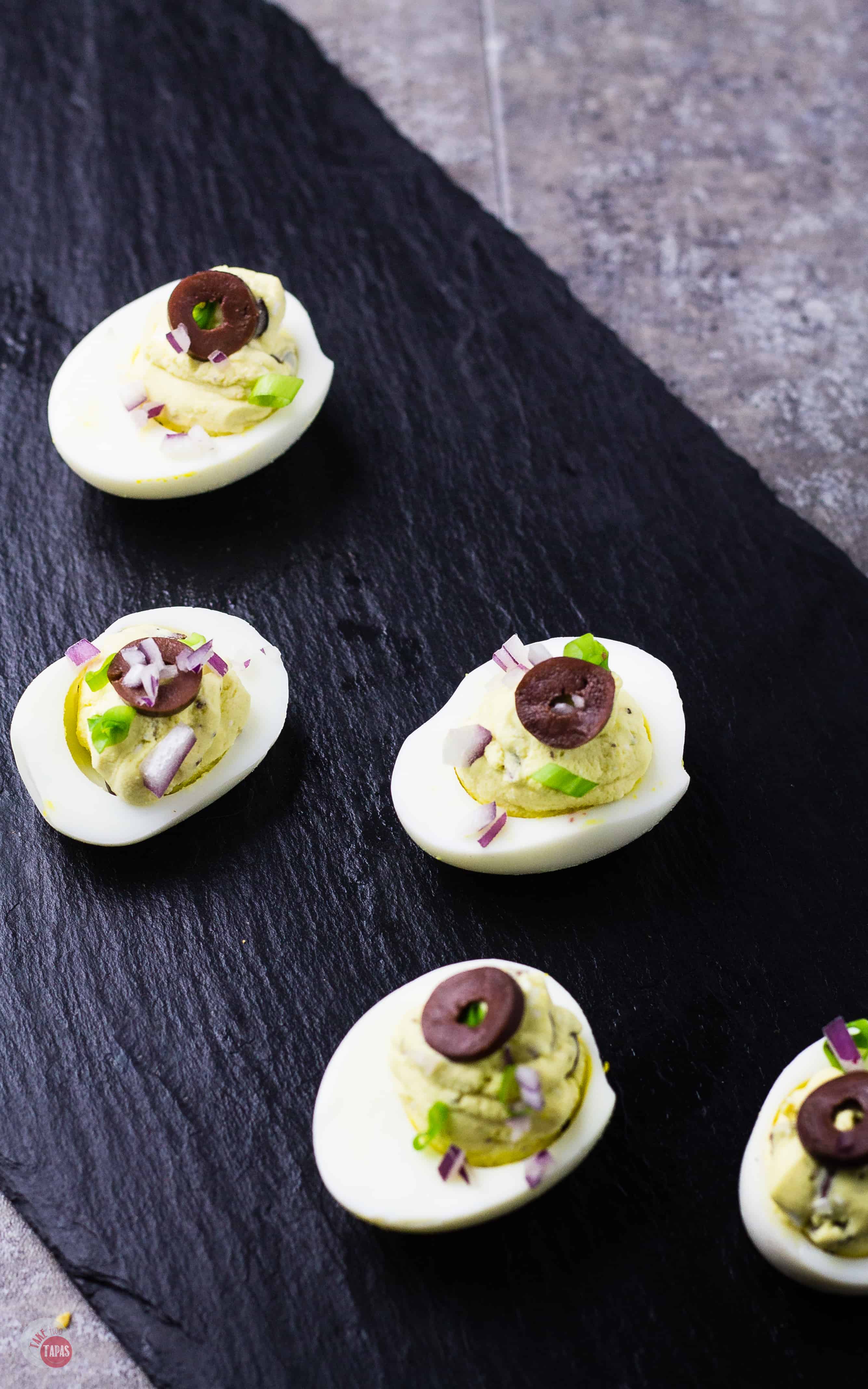 Mediterranean Deviled Eggs shine with briny olives and salty feta cheese | Take Two Tapas | #Mediterranean #Feta #DeviledEggs #Kalamata #Olives #Easter #MothersDay